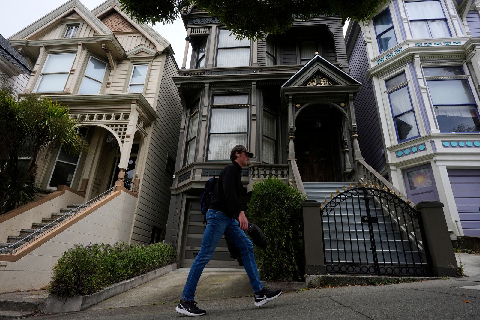 A man walks past the house where the original members of the Grateful Dead music group lived in San Francisco, Saturday, July 19, 2025. (AP Photo/Godofredo A. Vasquez)