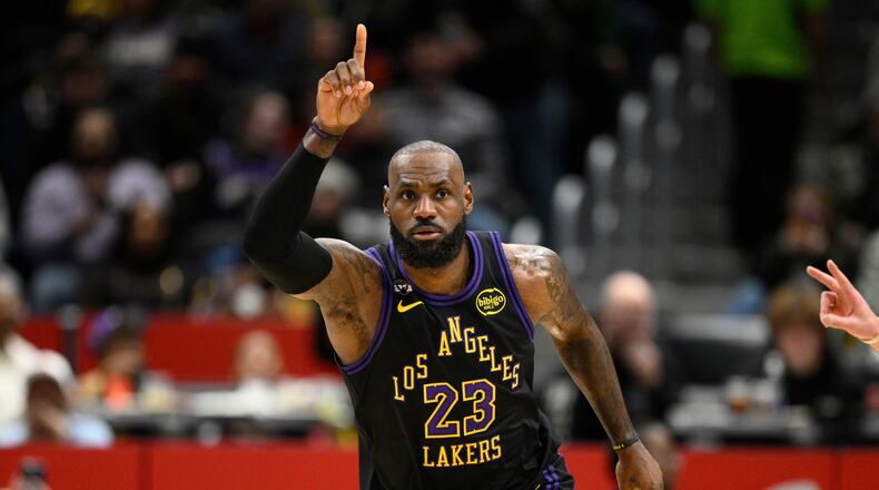 Los Angeles Lakers forward LeBron James gestures after he scored during the first half of an NBA basketball game against the Washington Wizards, Friday, Jan. 30, 2026, in Washington. (AP Photo/Nick Wass)