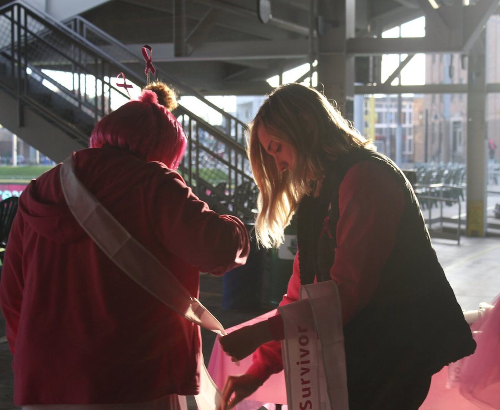 A breast cancer survivor receives her sash before last year’s Making Strides Against Breast Cancer walk in downtown Dayton. CONTRIBUTED
