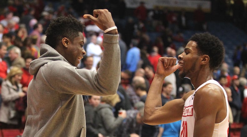 Dayton’s Kostas Antetokounmpo and Xeyrius Williams celebrate a victory over St. Joseph’s on Tuesday at UD Arena. David Jablonski/Staff