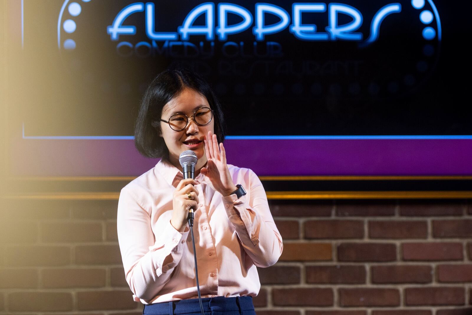 Corinna Yee performs during Stand Up For Climate, a comedy show at Flappers Comedy on Thursday, March 20, 2025, in Burbank, Calif. (AP Photo/Ethan Swope)
