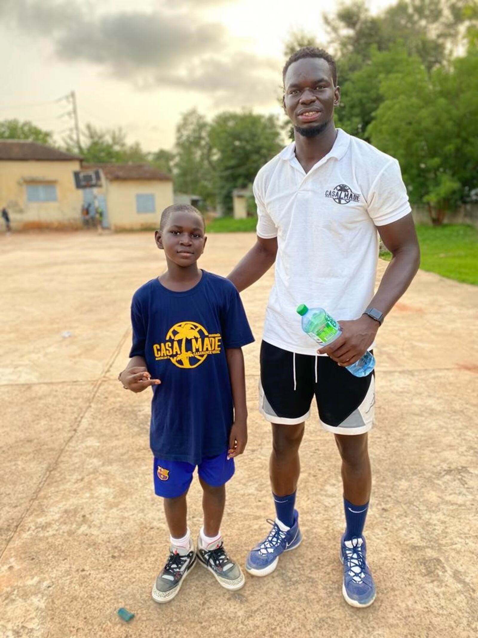 Central State basketball player Ibrahima Jarjou working with kids at  the Casamance Made basketball camp he put on back in his hometown of Bignona, Senegal.  Along with instruction, kids were given basketball shoes he had collected back in the United States or bought with money donated to the camp, as well as t-shirts, and food (Contributed Photo)