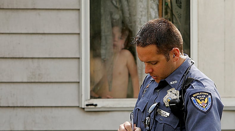 Middletown patrol officer Phil Salm checks on the wellbeing of children in a west Middletown neighborhood in 2006. Photo by Jim Noelker