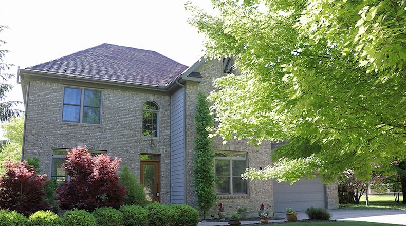Listed for $485,000 by Sibcy Cline Realtors, the brick-and-frame home at 1394 Meadowlands Drive sits on an acre lot within the Meadowlands subdivision of Fairborn. Contributed photos by Kathy Tyler