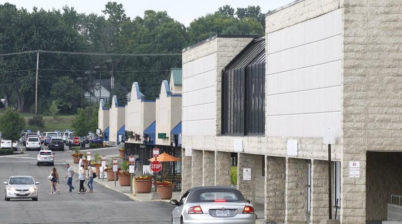Larry Dillin LLC has released additional plans for a proposed development to be built on land around the former Kroger on Ohio 48, something celebrated by Centerville officials. This view looking south shows the now-closed Kroger in Centerville Place. STAFF