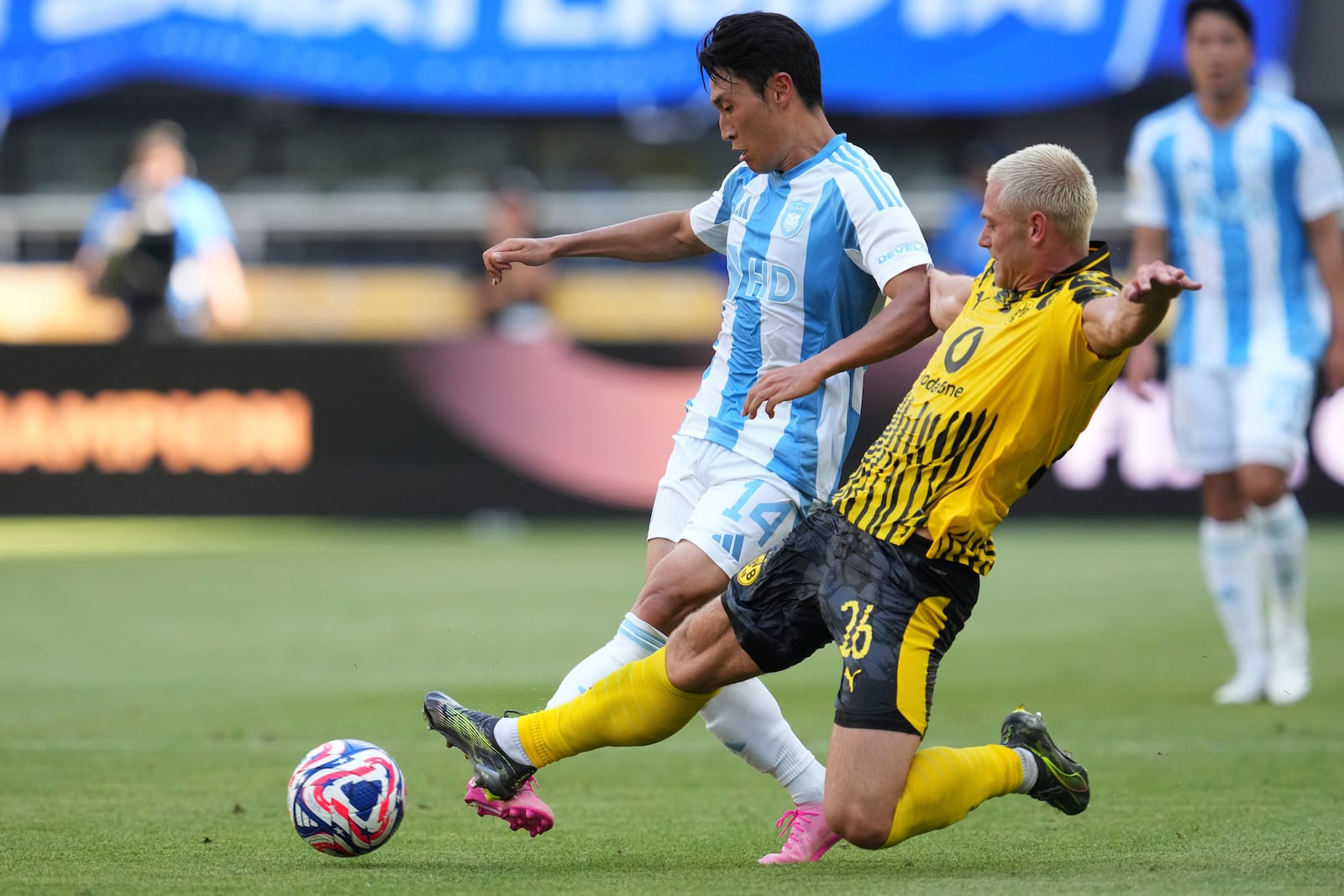 Borussia Dortmund's Julian Ryerson, right, tries to stop Ulsan HD's Lee Jin-hyun during the Club World Cup Group F soccer match between Borussia Dortmund and Ulsan in Cincinnati, Wednesday, June 25, 2025. (AP Photo/Jeff Dean)