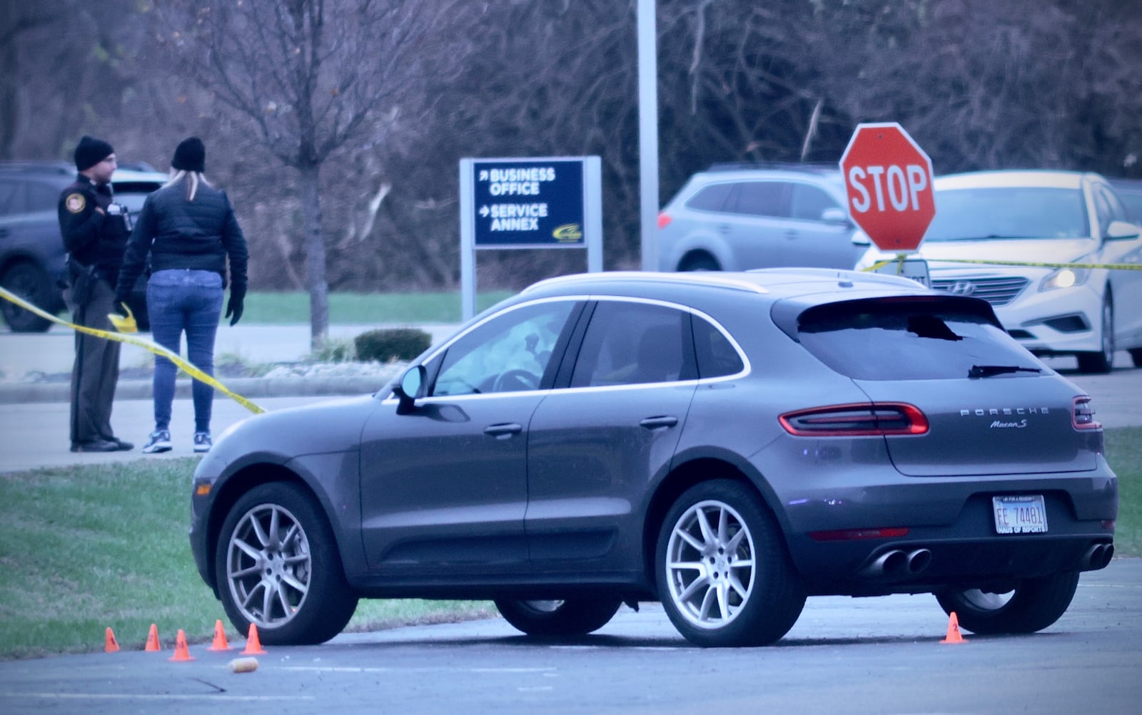 A vehicle with evidence markers near its front wheel after a shooting incident in the Sportsplex parking lot near Dayton Road on Sunday, Nov. 30, 2025 in Fairborn. MARSHALL GORBY / CONTRIBUTED PHOTO