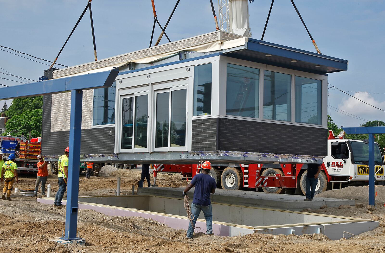 In this May 2024 file photo, a modular 7 Brew drive-thru in Springfield is lowered into place with the help of a large crane. A large crowd gathered to watch as the business was lifted off an oversized tractor trailer and placed on its foundation. Two sections of the roof were then hoisted into place on top. FILE