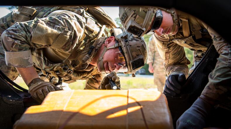 Airman 1st Class Jace Zook, and Tech. Sgt. Jesse Wibben, 48th Civil Engineer Squadron, assess the bomb inside a car trunk during the Warfighter Challenge in May 2018 at Eglin Air Force Base, Fla.  (U.S. Air Force photo/Samuel King Jr.)