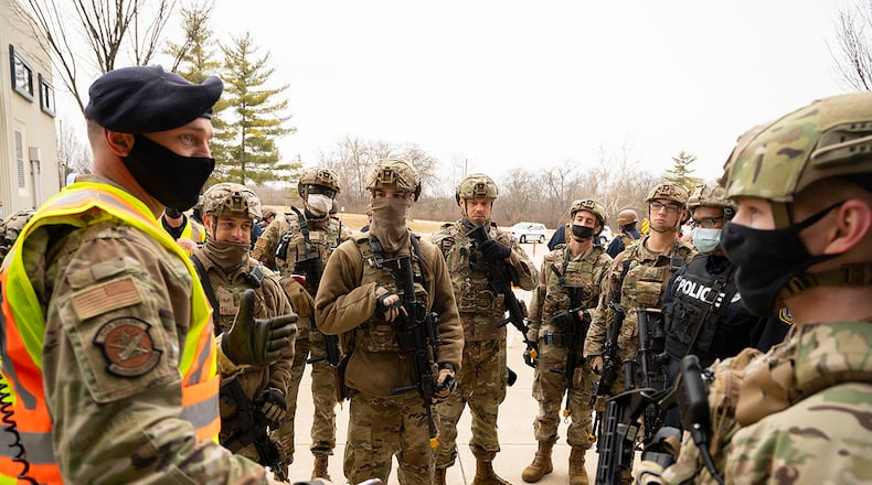 A member of the 88th Air Base Wing’s inspection team (left) speaks with 88th Security Forces Squadron Defenders at the end of an active-shooter exercise Feb. 23 at Wright-Patterson Air Force Base. The exercise gave first responders, including police, fire and medical personnel, the opportunity to practice coordinating emergency actions and procedures. U.S. AIR FORCE PHOTO/R.J. ORIEZ