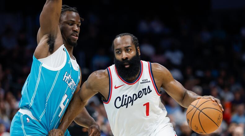 Los Angeles Clippers guard James Harden, right, drives to the basket against Charlotte Hornets guard Sion James during the first half of an NBA basketball game in Charlotte, N.C., Saturday, Nov. 22, 2025. (AP Photo/Nell Redmond)