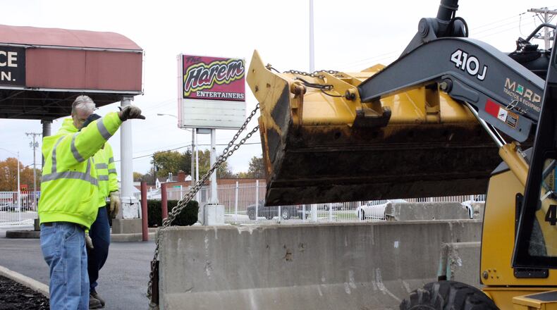 Workers placed concrete barriers around the parking lot of The Harem strip club on Monday. On Oct. 31, a Montgomery County judge ordered the club closed for one year after the Montgomery County Prosecutor's Office sought an injunction declaring the club a public nuisance following a 9-month investigation into allegations of prostitution and illegal drug sales at the club. CHUCK HAMLIN/STAFF