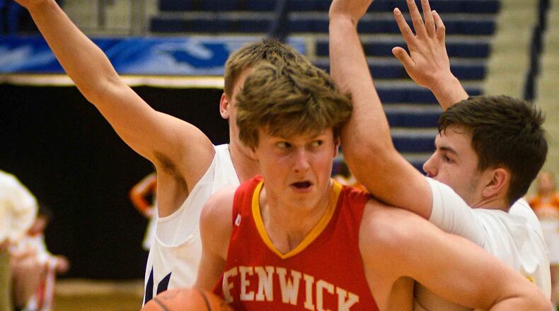 Fenwick's A.J. Braun (20) gets past Monroe's Nick Osterman (2) on his way to the basket during a Division II sectional basketball game Wednesday, Feb. 27, at Fairmont's Trent Arena. Fenwick won 60-39. ROB MCCULLEY/RAM PHOTOGRAPHY