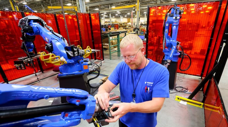 Yakasawa America Manufacturing Technician Todd Prenger works on the MA2010 welding Robot in the welding cell area. JIM WITMER/STAFF