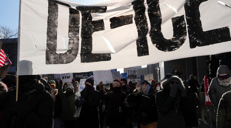 People protest against ICE (Immigration and Customs Enforcement) in Minneapolis, Sunday, Jan. 25, 2026. (AP Photo/Adam Gray)