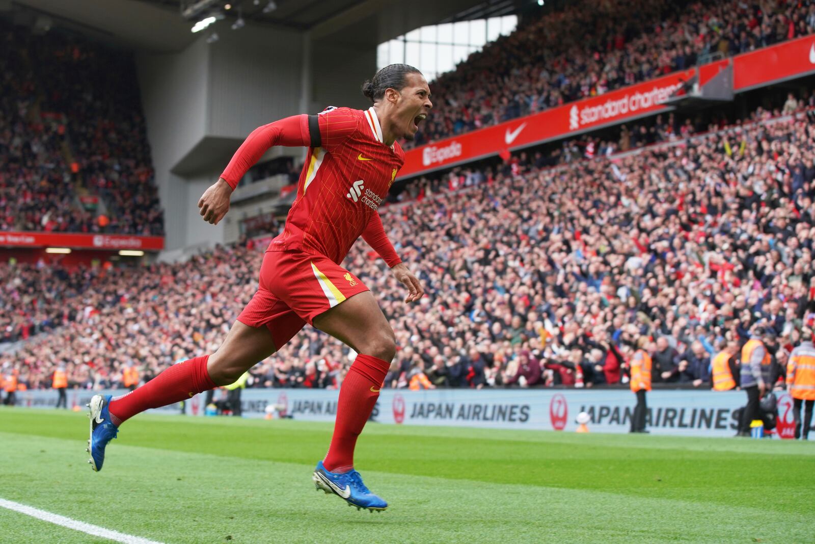 Liverpool's Virgil van Dijk celebrates after scoring his side's second goal during the English Premier League soccer match between Liverpool and West Ham United at Anfield in Liverpool, Sunday, April 13, 2025. (AP Photo/Ian Hodgson)