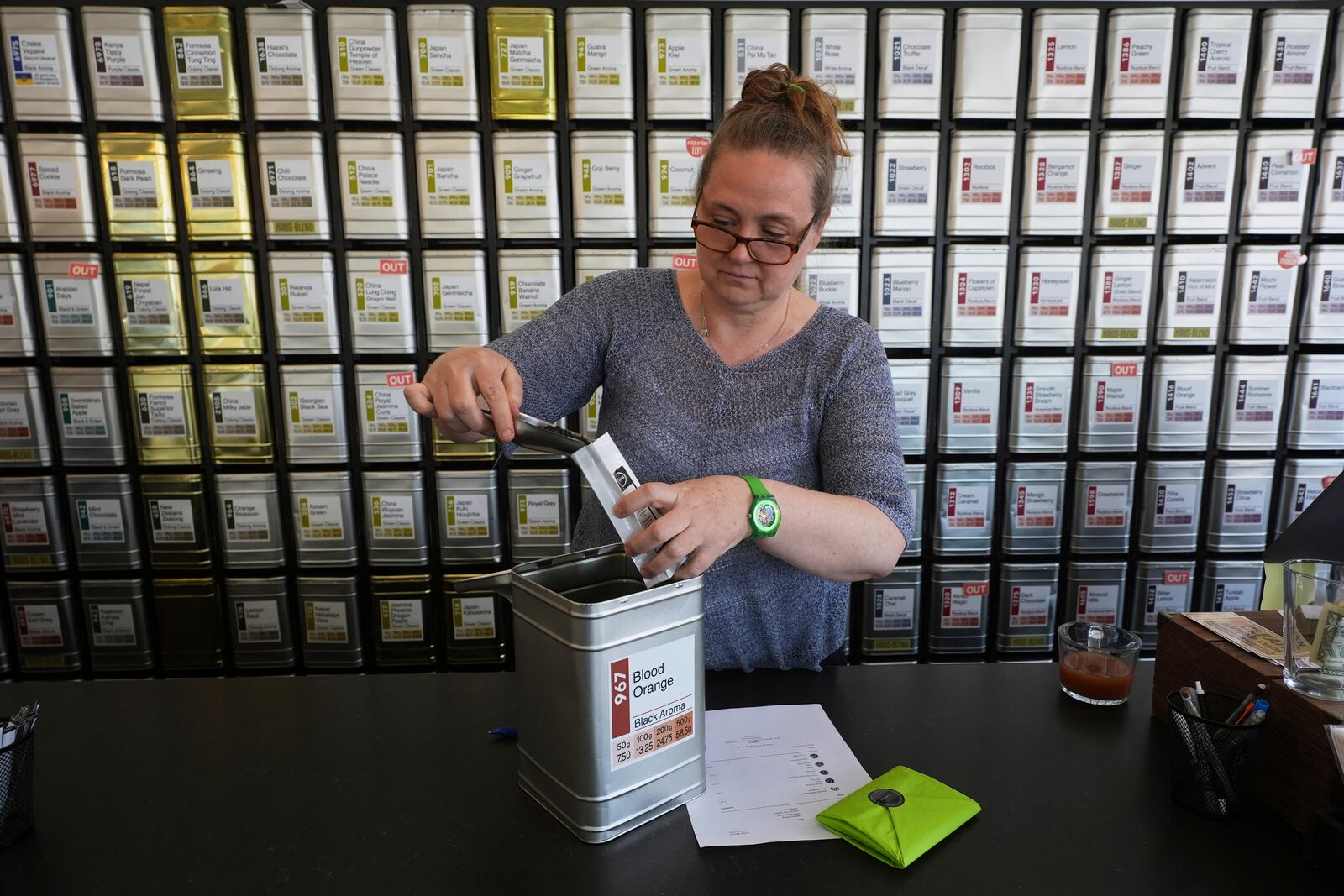 Owner Lisa McDonald packages loose leaf tea orders at the TeaHaus Thursday, April 24, 2025, in Ann Arbor, Mich. (AP Photo/Paul Sancya)
