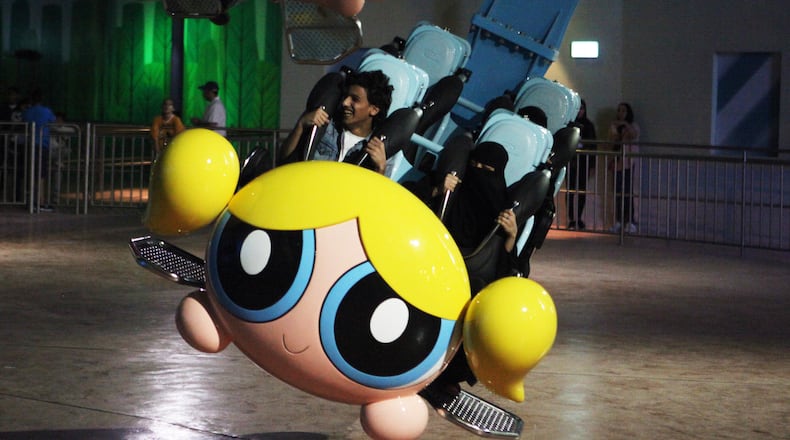 People shout as they experience the Powerpuff Girls - Mojo Jojo’s Robot Rampage ride at the IMG Worlds of Adventure amusement park in Dubai, United Arab Emirates, on Wednesday, Aug. 31, 2016. The IMG Worlds of Adventure indoor theme park opened Wednesday in Dubai, hoping to draw thrill seekers to its air-conditioned confines. (AP Photo/Jon Gambrell)