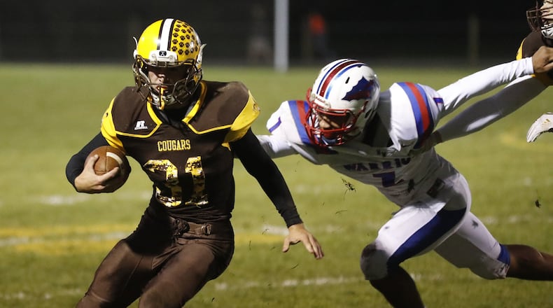 Kenton Ridge’s Carson Jones avoids a tackle by Northwestern’s Taveont Dennis-Miller. Bill lackey/Staff