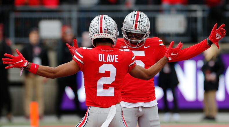 Ohio State receiver Garrett Wilson, right, celebrates his touchdown against Michigan State with teammate Chris Olave during the first half of an NCAA college football game Saturday, Nov. 20, 2021, in Columbus, Ohio. (AP Photo/Jay LaPrete)