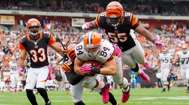 CLEVELAND, OH - OCTOBER 14: Tight end Jordan Cameron #84 of the Cleveland Browns dives for extra yards while under pressure from free safety Reggie Nelson #20, outside linebacker Vontaze Burfict #55 and defensive back Chris Crocker #33 of the Cincinnati Bengals during the fourth quarter at Cleveland Browns Stadium on October 14, 2012 in Cleveland, Ohio. The Browns defeated the Bengals 34-24. (Photo by Jason Miller/Getty Images)