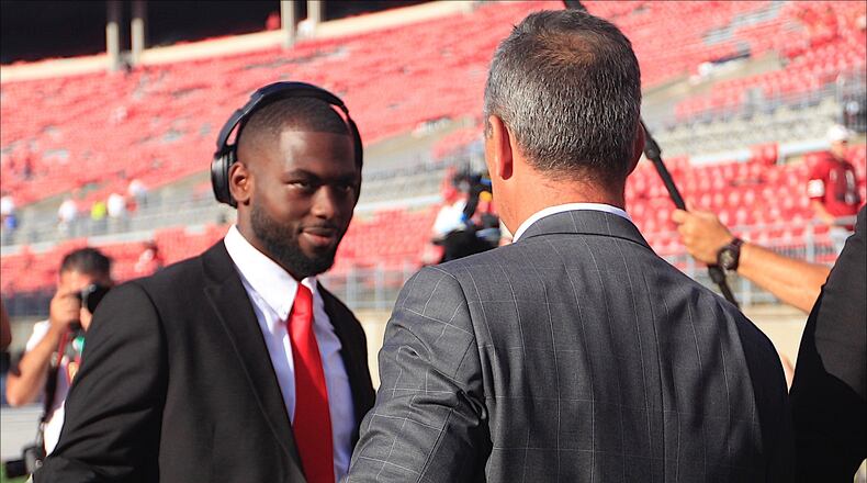 Ohio State's Urban Meyer greets J.T. Barrett as the Buckeyes arrive at Ohio Stadium before a game against Oklahoma on Saturday, Sept. 9, 2017, in Columbus. David Jablonski/Staff