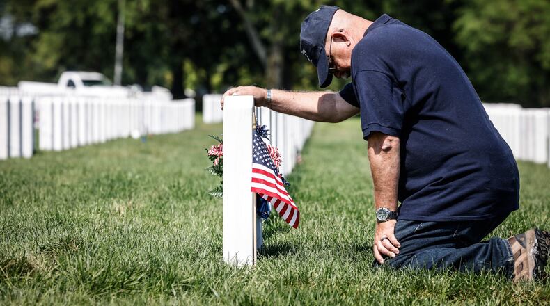Fairborn resident and retired Air Force Master Sgt. Henry Harlow delivers a flag to friend buried at the Dayton National Cemetery on West Third Street in 2022. JIM NOELKER/STAFF