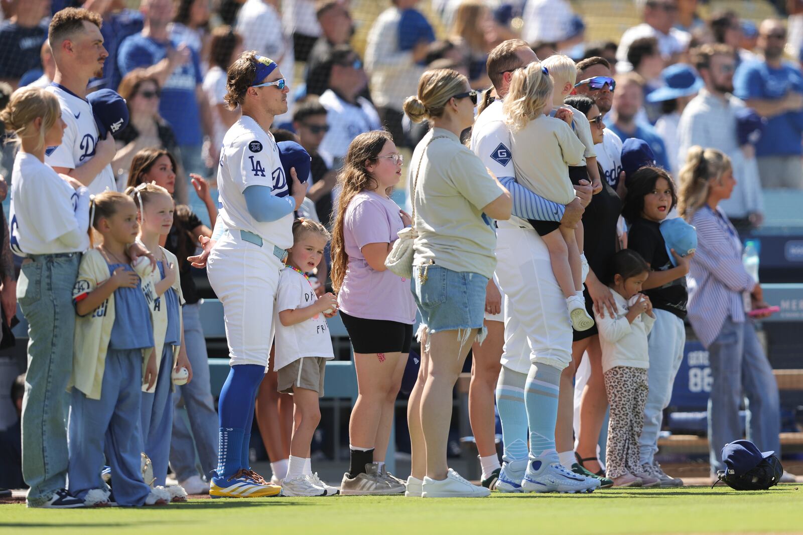 FILE - Los Angeles Dodgers' Enrique Hernández stands for the national anthem with his daughter before a baseball game against the San Francisco Giants in Los Angeles, Sunday, June 15, 2025. (AP Photo/Jessie Alcheh, File)