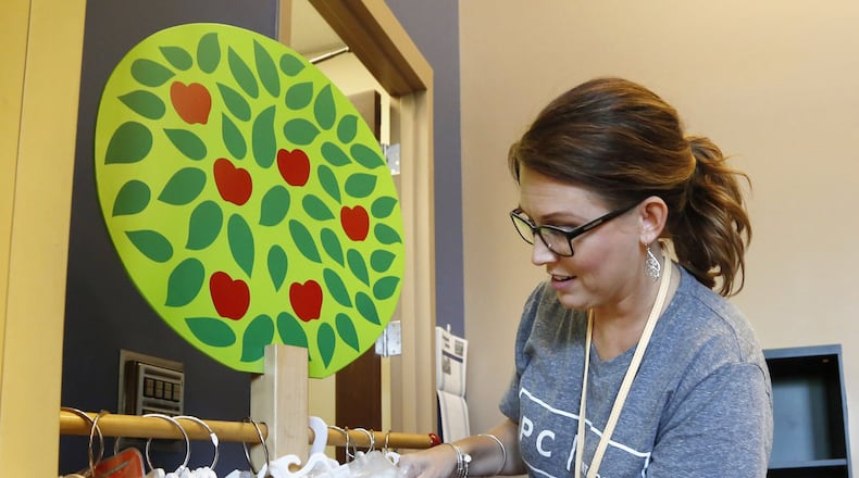 Kinder Elementary School Librarian Michelle Crespo sorts through books with audio packages as she prepares for the opening of the school year this week in Miamisburg. TY GREENLEES / STAFF