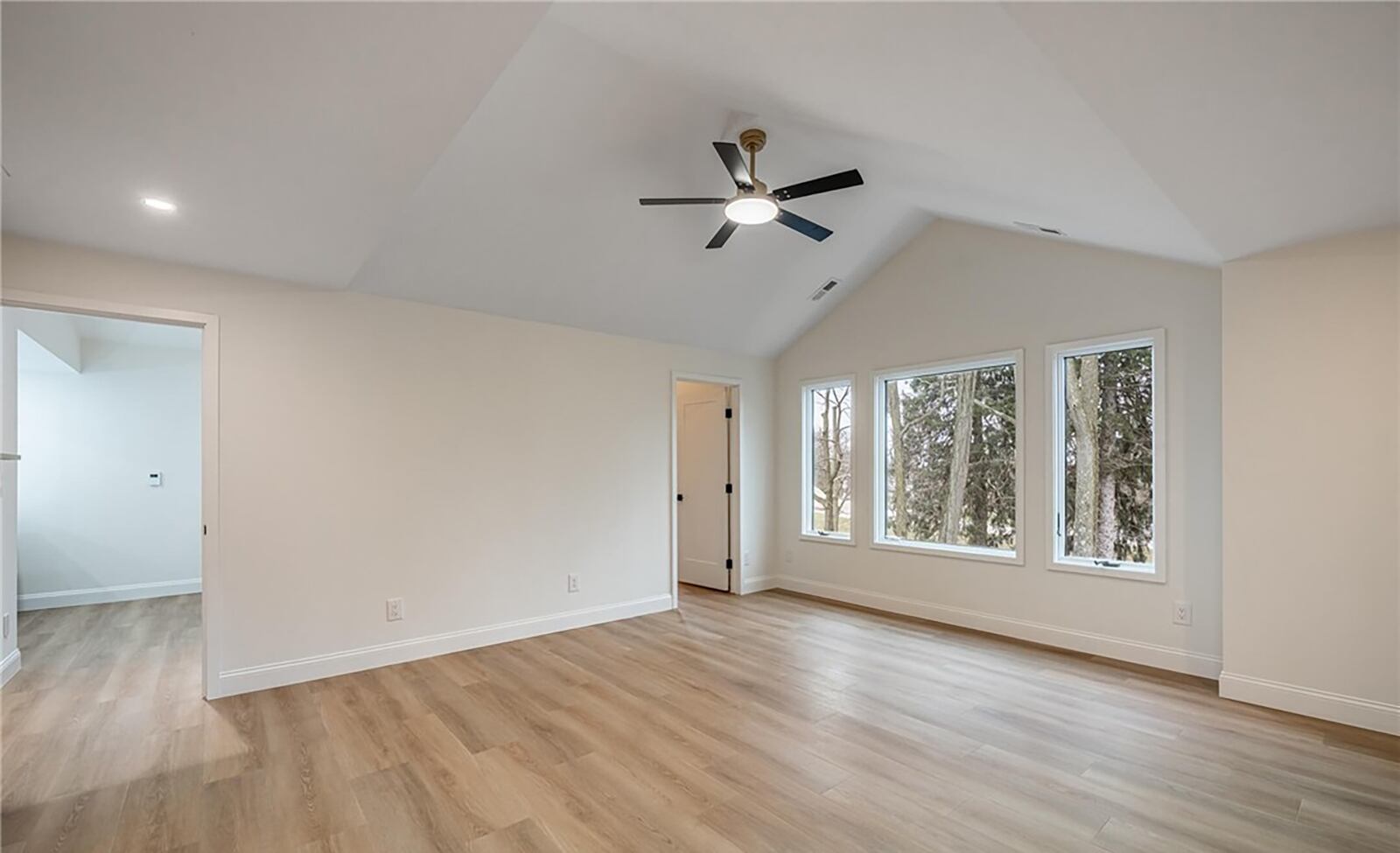 the second floor primary bedroom suite has LVP flooring, a vaulted ceiling and a ceiling fan. There is a walk in closet and ensuite bathroom. CONTRIBUTED