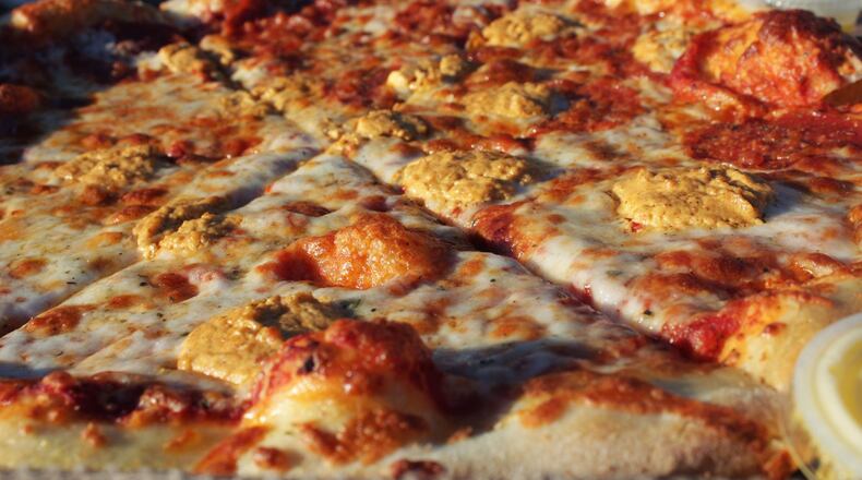 Pizza Bandit in Dayton has added harissa cream cheese from Ghostlight Coffee as a pizza topping as part of a collaboration between the businesses. CONTRIBUTED