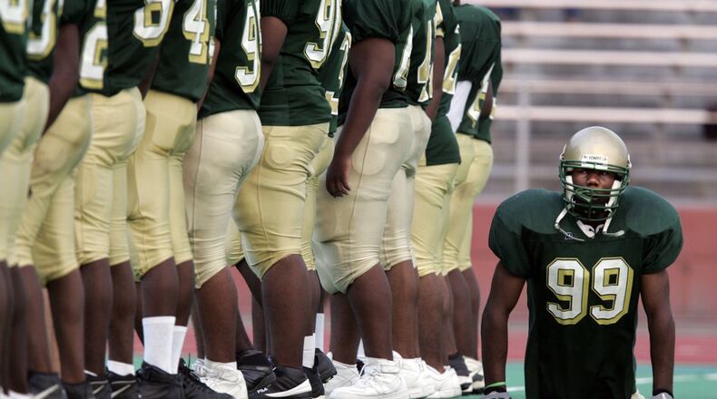 Dayton’s Colonel White’s Bobby Martin moves behind teammates as they line up on the field prior to a game vs. Dunbar in 2005. Despite being born without legs, Martin played defensive line, keeping up with and taking down two-legged players twice his size. Jim Witmer/DDN FILE