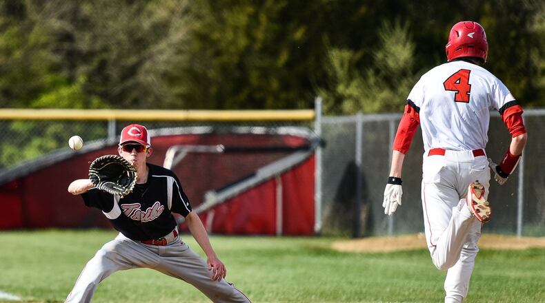 Carlisle’s Caleb Stewart tags stretches to get Madison’s Jake Edwards out at first base during their game Thursday, April 26 at Madison Junior Senior High School. NICK GRAHAM/STAFF