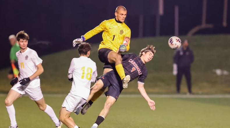 Centerville High School senior Hudson Day clears the ball past St. Charles senior Thomas Thornton during their Division I regional final match on Sunday, Nov. 2 at Wright State University's Alumni Field. The Cardinals won 2-0. MICHAEL COOPER / STAFF PHOTO