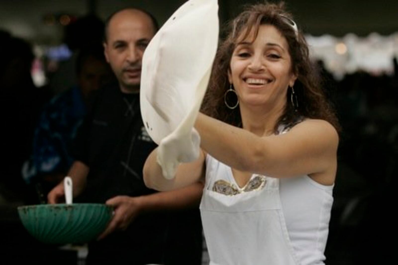 Claire Daoud (of CedarLand Lebanese Restaurant on Linden Ave.) tosses dough for mountain bread at the Dayton Lebanese Festival Sunday, Aug. 30.