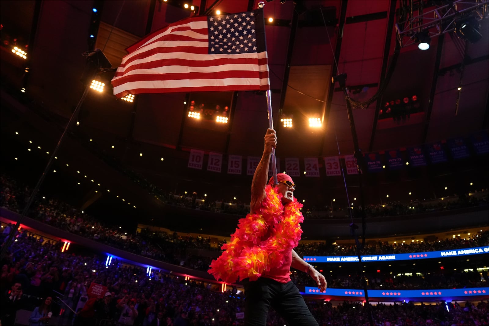 FILE - Hulk Hogan waves an U.S. flag before Republican presidential nominee, former President Donald Trump, speaks at a campaign rally at Madison Square Garden, Oct. 27, 2024, in New York. (AP Photo/Alex Brandon, File)