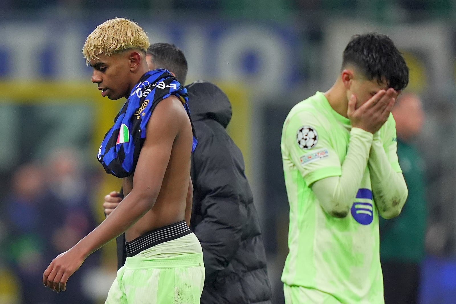 Barcelona's Lamine Yamal, left, reacts after the Champions League semifinal second leg soccer match between Inter Milan and Barcelona at San Siro stadium in Milan , Italy, Tuesday, May 6, 2025. (Spada/LaPresse via AP)