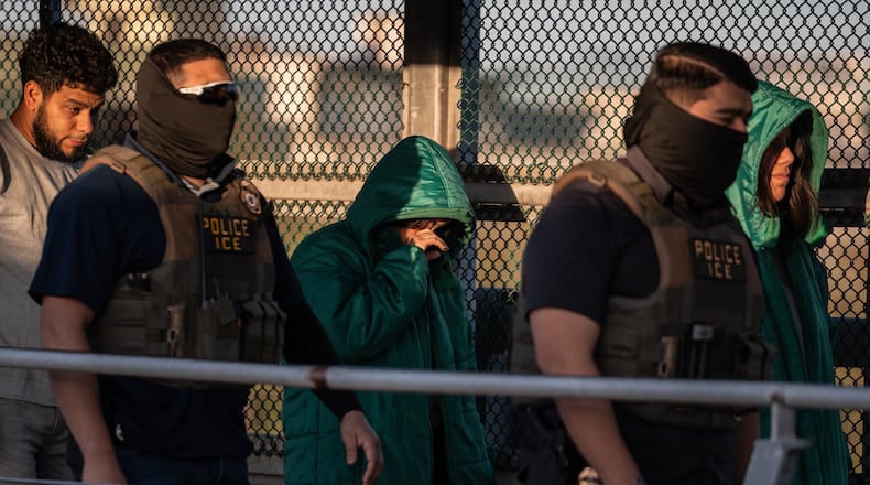 A group of undocumented migrants is deported by U.S. Immigration and Customs Enforcement agents across the McAllen–Hidalgo–Reynosa International Bridge in McAllen, Texas, Friday, March 13, 2026. Dozens of migrants from countries including Cuba, Venezuela, Haiti, China, Guatemala and El Salvador were handed over to Mexican authorities. (AP Photo/Felix Marquez)