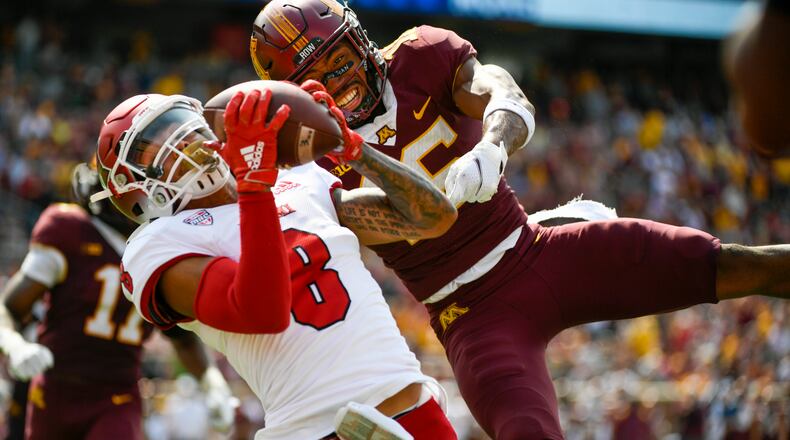 Miami-Ohio wide receiver Mac Hippenhammer (8) catches a 33-yard pass for a touchdown in front of Minnesota defensive back Coney Durr during the second half of an NCAA college football game on Saturday, Sept. 11, 2021, in Minneapolis. Minnesota won 31-26. (AP Photo/Craig Lassig)