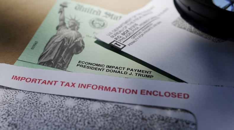 FILE - In this April 23, 2020, file photo, President Donald Trump’s name is seen on a stimulus check issued by the IRS to help combat the adverse economic effects of the COVID-19 outbreak. (AP Photo/Eric Gay, File)