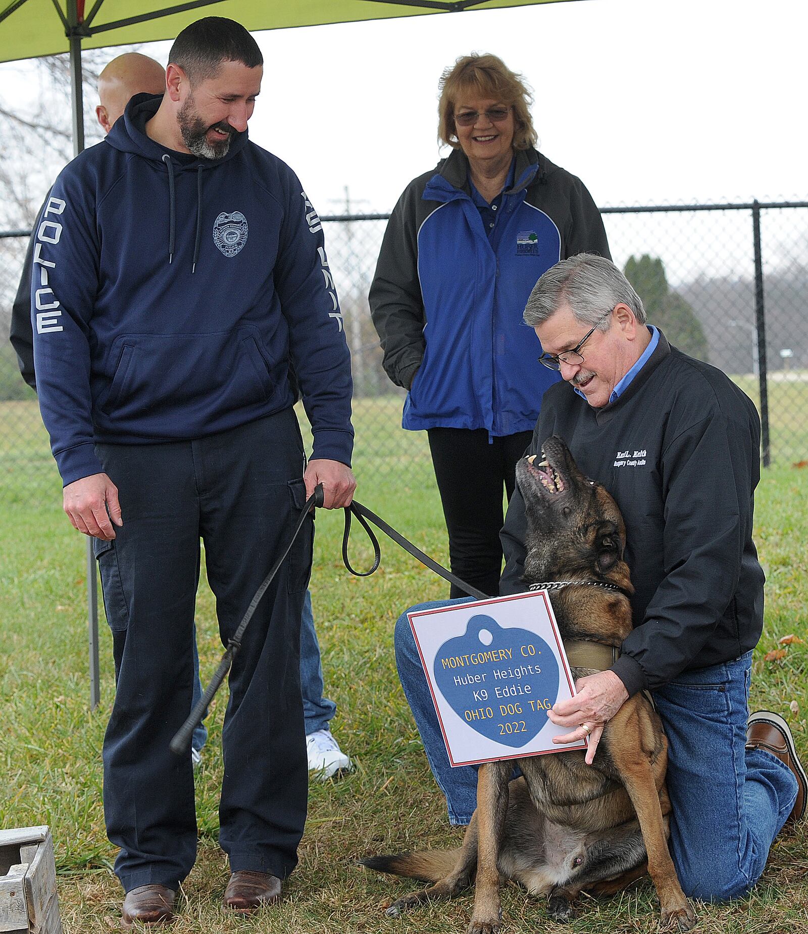 Montgomery County Officials Kick-Off Dog License Sales Wednesday, Dec. 1, 2021 at  Montgomery County Auditor Karl Keith presented Huber Heights’ police K-9 Eddie and his handler Officer Cory Siegrist with a 2022 dog license