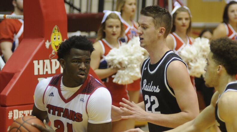 WSU’s Parker Ernsthausen (22) gets help from teammate Justin Mitchell against Detroit’s Jaleel Hogan (with ball). Wright State defeated host Detroit Mercy 85-72 in a men’s college basketball Horizon League game at historic Calihan Hall on Saturday, Dec. 31, 2016. MARC PENDLETON / STAFF