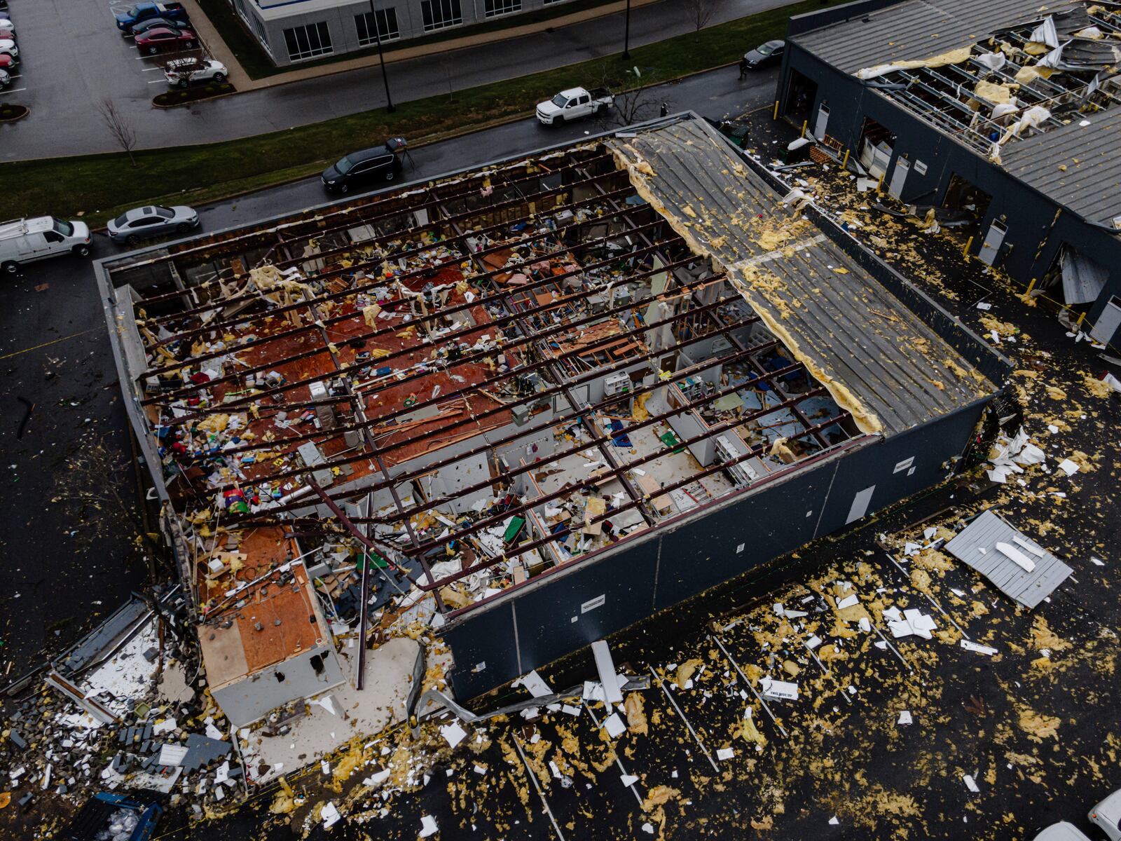 In an aerial view, damaged structures are seen at the Triad Building, a business plaza, after severe weather passed through Thursday, April 3, 2025, in Louisville, Ky. (AP Photo/Jon Cherry)