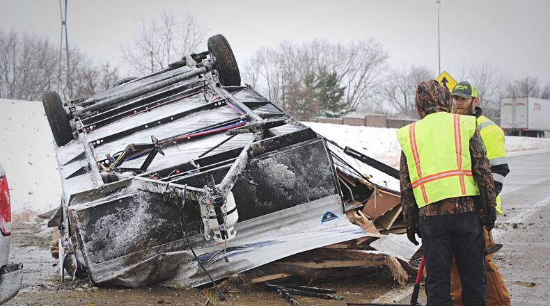 A pickup truck towing a trailer on I-70 west lost control because of weather conditions Tuesday morning. The trailer rolled, landing on the entrance ramp from Brandt Pike. STAFF/MARSHALL GORBY\STAFF