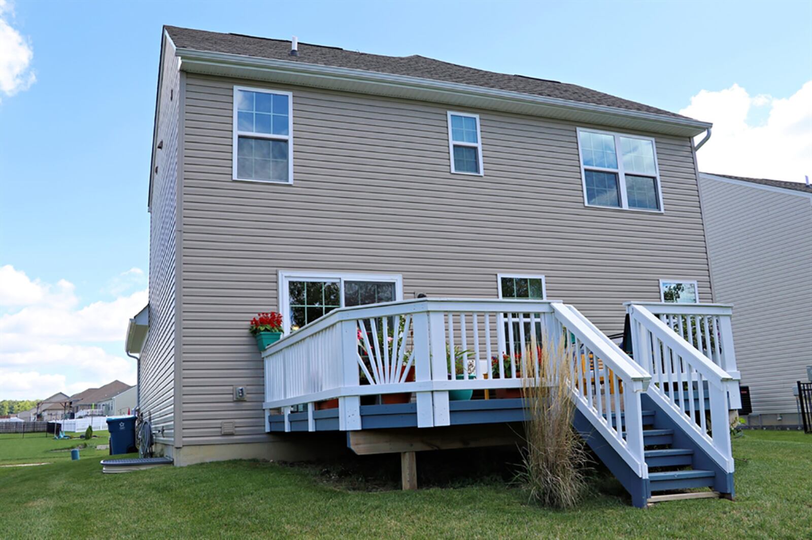 Sliding patio doors open off the dining area to the balcony wooden deck with steps that lead down to the back yard. CONTRIBUTED PHOTO BY KATHY TYLER