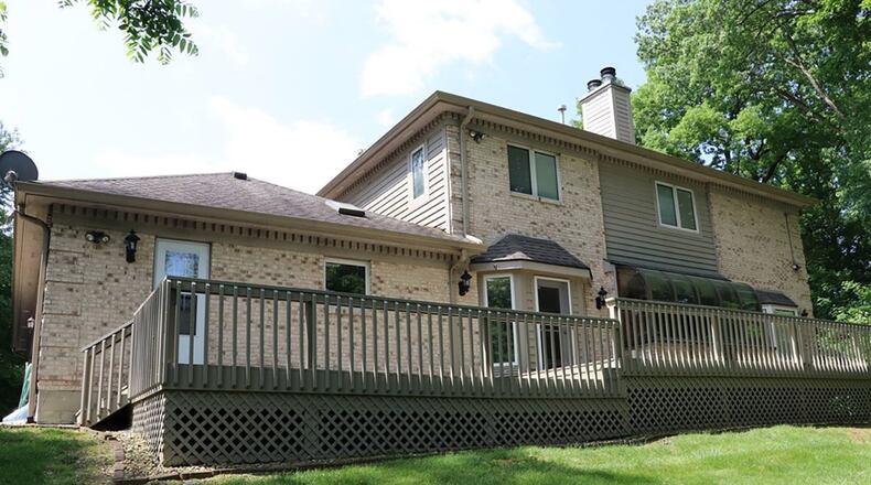 A wooden deck is accessible from the breakfast room and laundry room.