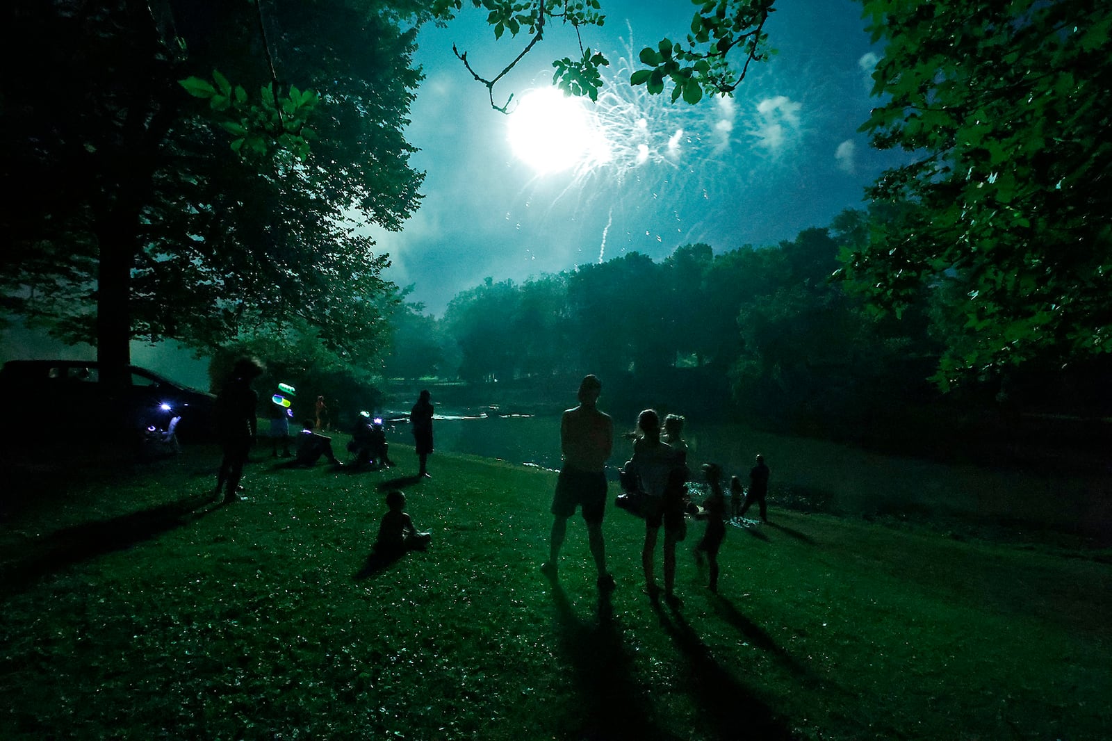 The shores of Buck Creek were lined with families wearing their patriotic best and waving sparklers during the Buck Creek Boom fireworks display Wednesday, July 3, 2024. BILL LACKEY/STAFF