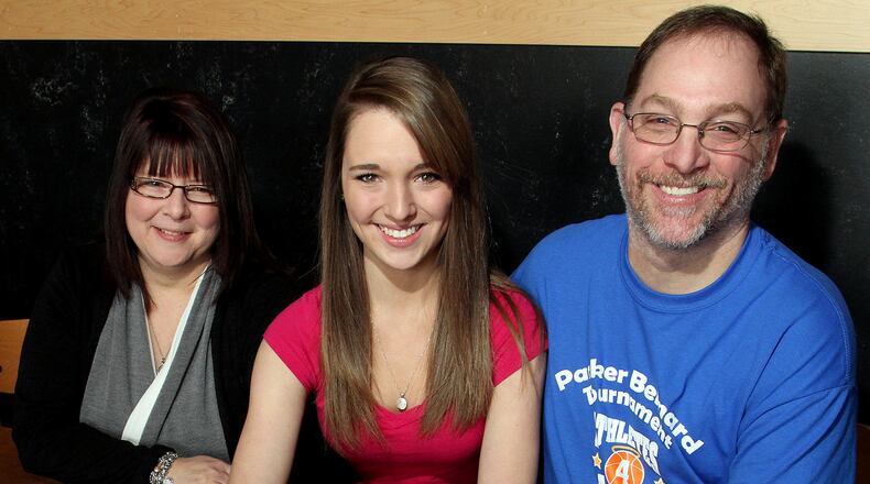 Sheila and Scott Bernard, and their daughter, Peyton Bernard, 18, a senior at Bellbrook High School, show off their yellow bracelets for their son and brother, Parker, during a fundraiser at BW3's in Centerville Sunday, March 3, 2013. Parker Bernard, 11, died during surgery to remove a brain tumor in 2012. CONTRIBUTED PHOTO BY E.L. HUBBARD