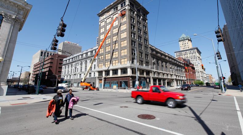 Workers board up windows at the Arcade complex's Commercial Building on Monday, April 22. CHRIS STEWART / STAFF