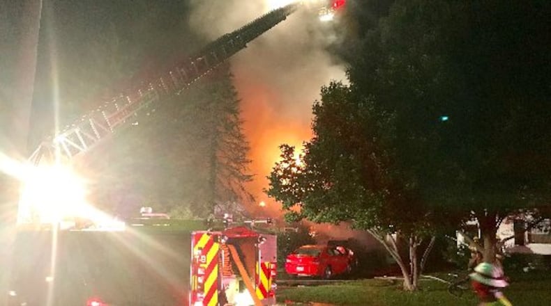 Flames light the early morning sky from on house fire on Dover Road in Springfield Aug. 30. DeAngelo Byrd/STAFF
